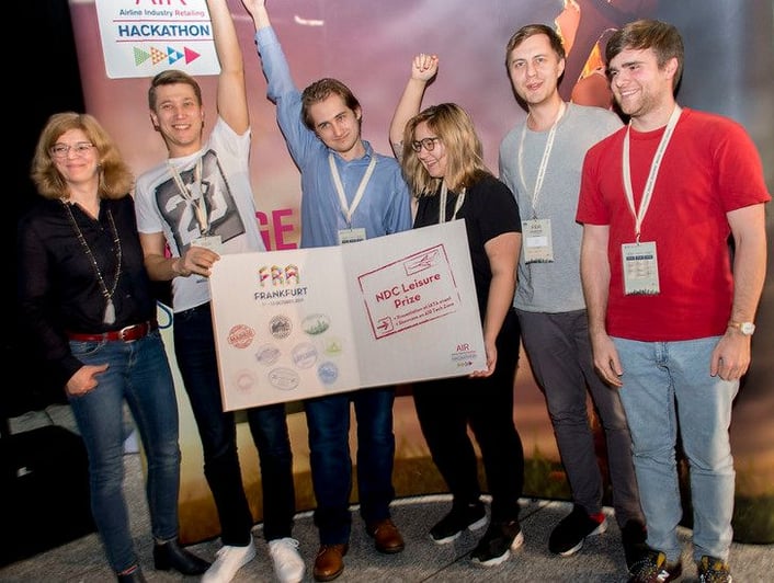 Photo to illustrate blog post about Cloverly team and API being featured at International Air Transport Association hackathon in Frankfurt, Germany, to help offset carbon emissions from air travel, showing winners of one category who used Cloverly to make air travel more carbon-neutral